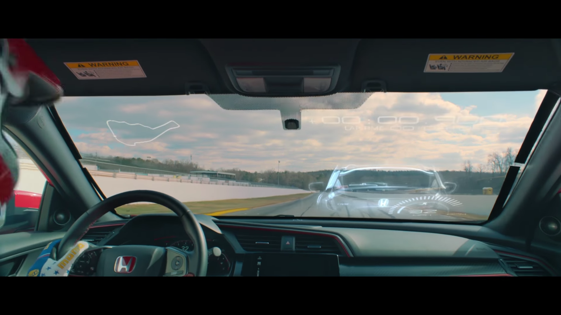 Honda Civic Type R mixed reality race shows a virtual car on the windshield of the real car.