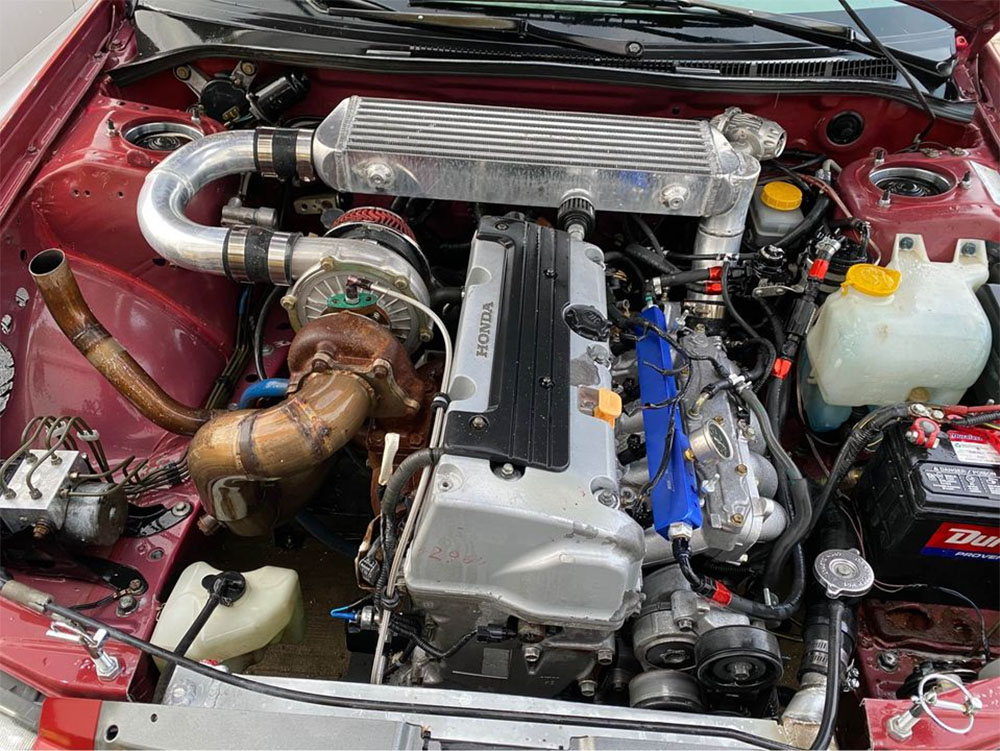 Turbo K24 in Subaru Outback Engine Bay Mounted to Five Speed Transmission